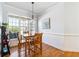 Cozy dining area with natural light and a wooden table with seating for four at 3999 Treemont Ln, Suwanee, GA 30024