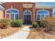 Charming front entrance featuring a stylish door and manicured bushes leading to a warm welcome at 3999 Treemont Ln, Suwanee, GA 30024