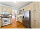 Well-appointed kitchen featuring stainless steel appliances and ample cabinet space at 3999 Treemont Ln, Suwanee, GA 30024