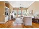 Inviting living room with fireplace, built-in shelving, and large windows at 3999 Treemont Ln, Suwanee, GA 30024