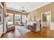 Bright living room featuring a fireplace, hardwood floors, and ample natural light at 3999 Treemont Ln, Suwanee, GA 30024