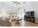 Bright living room features neutral color palette, tile floors, and ample natural light at 3999 Treemont Ln, Suwanee, GA 30024