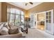 Inviting sitting area with plush seating, tall windows, and a view into the dining room at 3999 Treemont Ln, Suwanee, GA 30024