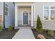 Inviting entrance with a blue door, stone accents, and manicured landscaping at 489 Hammons Way, Atlanta, GA 30315