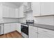 Well-equipped kitchen showcasing sleek appliances, crisp white cabinetry, and designer backsplash at 489 Hammons Way, Atlanta, GA 30315