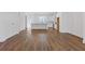 Open-concept living room leading to a modern kitchen with white cabinetry and stainless steel appliances at 489 Hammons Way, Atlanta, GA 30315