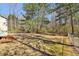 Spacious, fenced backyard with mature trees offering shade and privacy at 5537 Riverside Dr, Sugar Hill, GA 30518