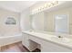 Bright bathroom with dual vanity, ample counter space, and a large mirror at 5537 Riverside Dr, Sugar Hill, GA 30518