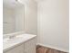 Bright bathroom featuring white cabinets, a white sink and a white shower at 5537 Riverside Dr, Sugar Hill, GA 30518