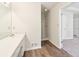 Bathroom featuring wood-look floors, a large mirror, and a white vanity with a sink, and a walk-in shower at 5537 Riverside Dr, Sugar Hill, GA 30518