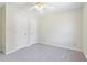 Bedroom featuring neutral carpet, paint, and ceiling fan, alongside two large closets at 5537 Riverside Dr, Sugar Hill, GA 30518