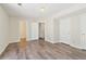 Bedroom featuring neutral walls, wood-look flooring and two doors at 5537 Riverside Dr, Sugar Hill, GA 30518