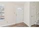 Bright foyer showcasing new flooring, white trim, and staircase access at 5537 Riverside Dr, Sugar Hill, GA 30518