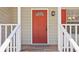 Close-up of a red front door with white trim and a welcoming entrance at 5537 Riverside Dr, Sugar Hill, GA 30518