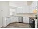 Functional kitchen featuring white cabinetry, stainless steel appliances, and new flooring at 5537 Riverside Dr, Sugar Hill, GA 30518