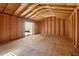 Unfinished shed interior with exposed beams, offering plenty of potential at 5537 Riverside Dr, Sugar Hill, GA 30518