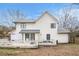 View of the back of a two-story house with white siding and a gray roof and a deck at 9556 River Ct, Jonesboro, GA 30238