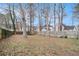 View of the backyard, enclosed with a wood fence and bare trees at 9556 River Ct, Jonesboro, GA 30238