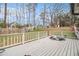 View of a wood deck overlooking the lawn, fence, and shed in the backyard at 9556 River Ct, Jonesboro, GA 30238