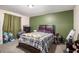 Bedroom featuring a queen bed, green accent wall, dark furniture, and carpeted floors at 9556 River Ct, Jonesboro, GA 30238