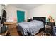 Bedroom with wood floors, queen bed, dark bed frame, and a window with green curtains at 9556 River Ct, Jonesboro, GA 30238