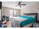 Cozy bedroom with a ceiling fan, natural light, and comfortable bed at 9556 River Ct, Jonesboro, GA 30238