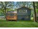 Exterior: Beautiful home featuring a wood deck, a spacious lawn, and mature trees at 2522 Candler Woods Dr, Decatur, GA 30032