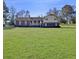 Expansive lawn surrounds a brick home, offering a picturesque and serene setting at 3415 Spot Rd, Cumming, GA 30040