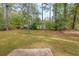 Lush backyard featuring mature trees and grass lawn at 5065 Hubert Dr, Powder Springs, GA 30127