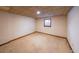 Unfinished basement with carpeted floor, window, and paneled ceiling at 5065 Hubert Dr, Powder Springs, GA 30127