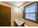 Bathroom with a single sink vanity, mirror, and a window at 5065 Hubert Dr, Powder Springs, GA 30127