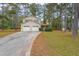 Charming two-story home with a two-car garage surrounded by mature trees and a well-maintained lawn at 5065 Hubert Dr, Powder Springs, GA 30127