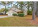 Traditional two-story home with a two-car garage and a cozy front porch, surrounded by a lush, green lawn at 5065 Hubert Dr, Powder Springs, GA 30127