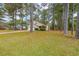 Well-manicured front yard with mature trees enhancing the curb appeal of this traditional-style two-story home at 5065 Hubert Dr, Powder Springs, GA 30127