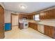An ample kitchen area showcases traditional wood cabinetry, white appliances, and neutral countertops at 5065 Hubert Dr, Powder Springs, GA 30127