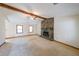 Spacious living room featuring a stone fireplace, exposed beam, neutral carpet and natural light at 5065 Hubert Dr, Powder Springs, GA 30127