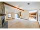 Open-concept living room featuring a stone fireplace and access to the kitchen and backyard at 5065 Hubert Dr, Powder Springs, GA 30127