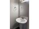 Pedestal sink and modern fixtures in a well-lit half bathroom at 5891 Raven Ln, Lithonia, GA 30058