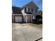 Charming two-story home with attached garage and well-maintained front yard at 5891 Raven Ln, Lithonia, GA 30058