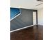 Stylish living room with dark stained wood floors and decorative accent wall at 5891 Raven Ln, Lithonia, GA 30058
