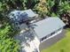 A bird's eye view of a single-story home surrounded by beautiful trees and featuring a spacious driveway at 7360 Fields Dr, Cumming, GA 30041
