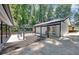 Stunning backyard featuring a covered patio with stylish pergola and flagstone hardscape surrounded by lush greenery at 7360 Fields Dr, Cumming, GA 30041