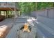 Outdoor deck with stone fire pit and built-in seating near the waterfront at 7360 Fields Dr, Cumming, GA 30041