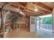 Unfinished basement with exposed wood beams and walkout access to the outdoor living space at 7360 Fields Dr, Cumming, GA 30041