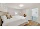 Well lit bedroom featuring a king bed, wood floors, and an entry to the bathroom at 7360 Fields Dr, Cumming, GA 30041
