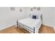 Cozy bedroom with a full bed, wood floors, white wainscoting and modern decor at 7360 Fields Dr, Cumming, GA 30041
