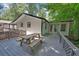 Outdoor deck area with a picnic table providing space for entertaining in wooded surroundings at 7360 Fields Dr, Cumming, GA 30041