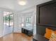 Entryway boasting a built-in bench, sun-drenched bay windows, and light hardwood floors at 7360 Fields Dr, Cumming, GA 30041