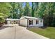 Charming single-story home with a well-manicured lawn and a long, private driveway at 7360 Fields Dr, Cumming, GA 30041