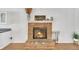 Traditional brick fireplace in living room is a focal point with mantel decor at 7360 Fields Dr, Cumming, GA 30041